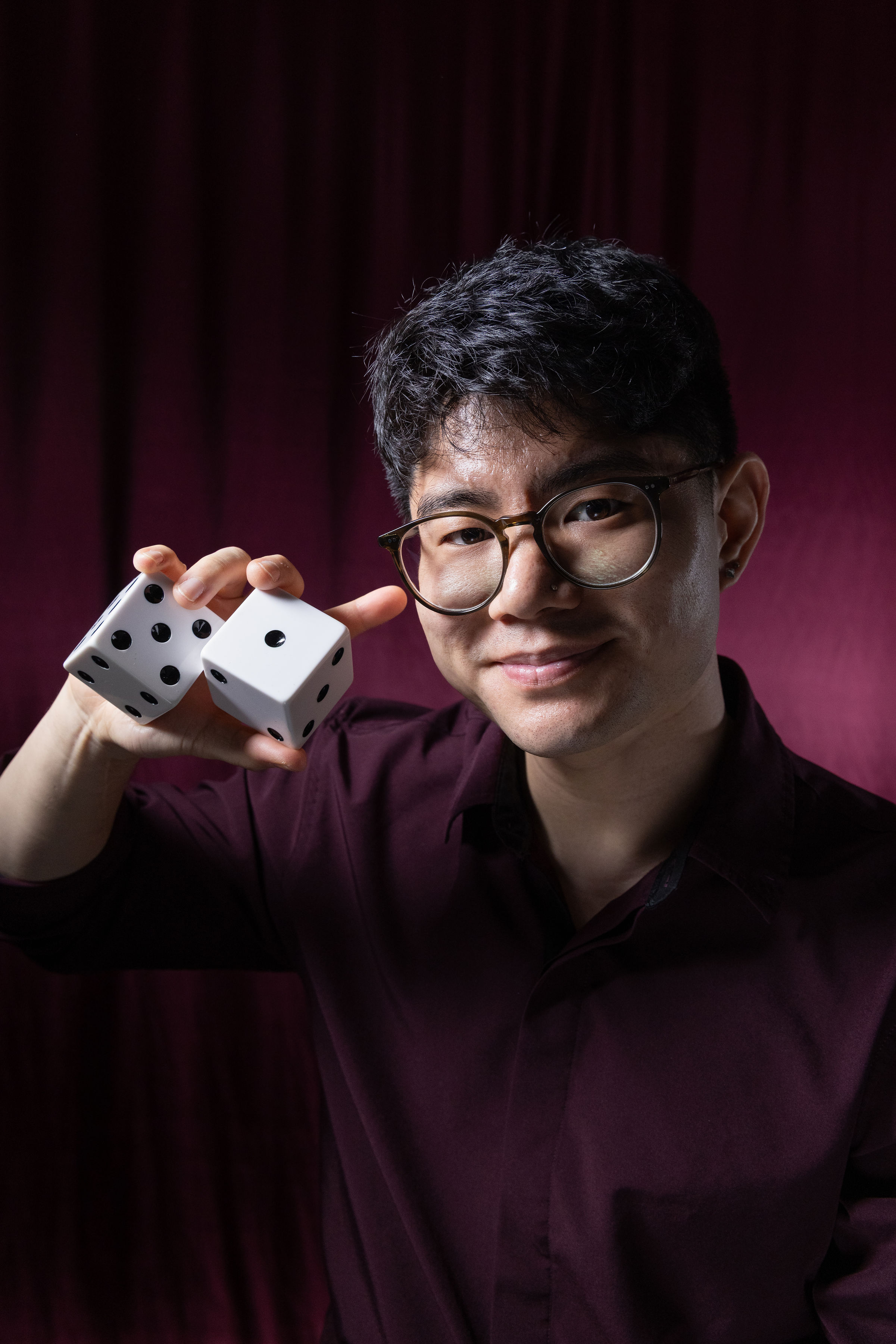 Professional headshot of Seattle magician Travis Kim, expert in close-up sleight-of-hand magic for events and parties.